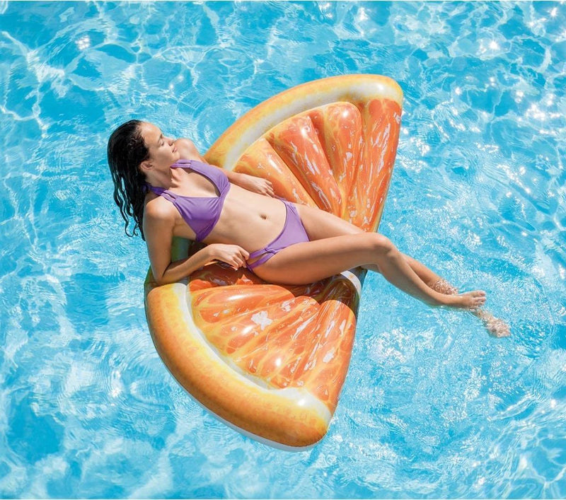 Laad afbeelding in galerijtoner, Een vrouw drijft op het water op een oranje luchtbed van Intex in de vorm van een sinaasappelschijf
